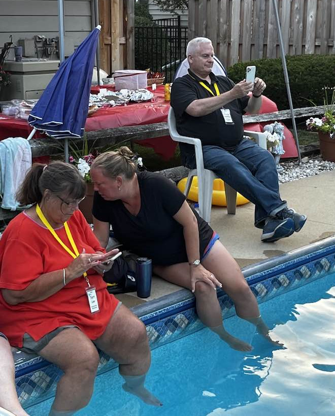 A couple fo women soak their feet in the pool