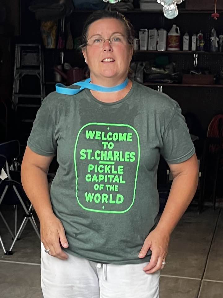 Woman wearing a St. Charles, pickle capital of the world T-shirt