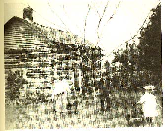 Log Cabin with several people standing in front of it