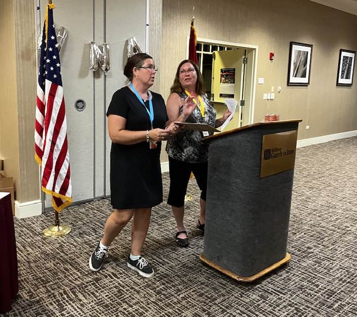 Two women at podium