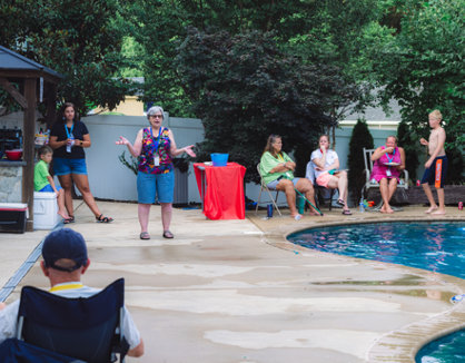 Several people around the edge of a pool