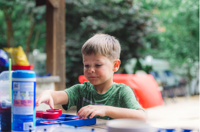 A kid in a green shirt playing a game